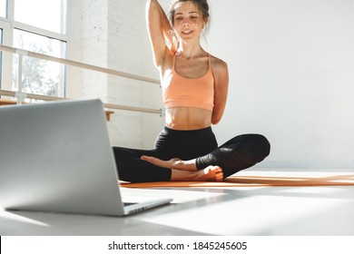 Fitness Instructor Having Virtual Yoga Class Using Video Call On Laptop. Remote Yoga Teacher Leads A Lesson For People