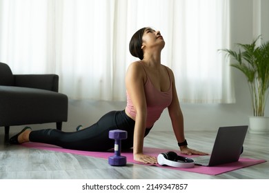 Fitness Instructor Having Virtual Yoga Class Using Video Call On Laptop. Remote Yoga Teacher Leads A Lesson For People