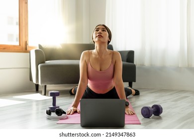 Fitness Instructor Having Virtual Yoga Class Using Video Call On Laptop. Remote Yoga Teacher Leads A Lesson For People