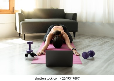 Fitness Instructor Having Virtual Yoga Class Using Video Call On Laptop. Remote Yoga Teacher Leads A Lesson For People