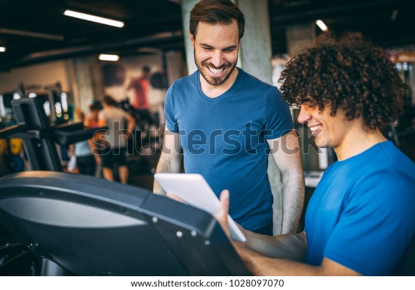 Fitness Instructor Showing Training Plan His Stock Photo 1028097070 ...