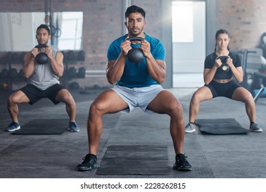Fitness, kettlebell and personal trainer with a man coach training a class in the gym for health. Exercise, workout and bodybuilder with a male athlete teaching students in a club for strong muscles