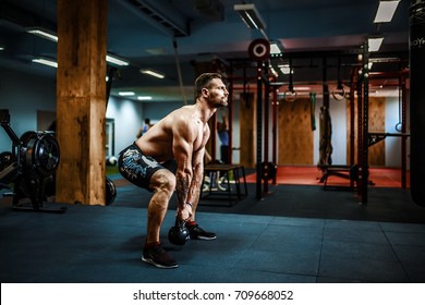 Fitness Kettlebells swing exercise bearded man workout at gym - Powered by Shutterstock