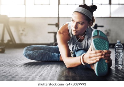 Fitness, legs and thinking with woman stretching on floor of gym for health or wellness. Exercise, vision and warm up for workout with athlete getting ready for improvement or training routine - Powered by Shutterstock