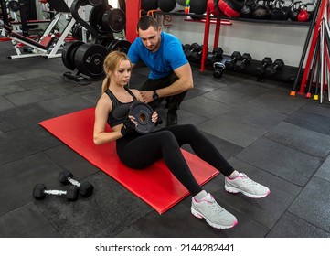 Fitness male trainer with his client working exercising at the gym. Energy concept, training