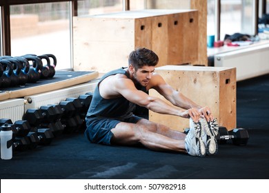 Fitness Man Doing Stretching In Gym