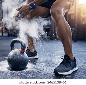 Fitness, man with a kettlebell and chalk his hands at the gym with a lens flare. Workout or exercise, health wellness or motivation and male athlete with powder for hand for sports training - Powered by Shutterstock