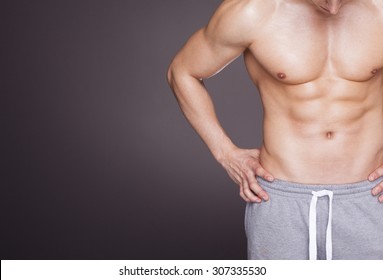 Fitness Man Showing Six Pack Abs On Grey Background