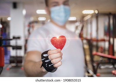 Fitness Man Shows The Heart On The Background Of The Sports Hall.