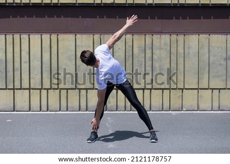 Athletic man warming up before running.