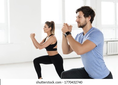 Fitness Man And Woman During Workout With In The Gym. Lunges Exercise For Glutes And Hips Muscles.