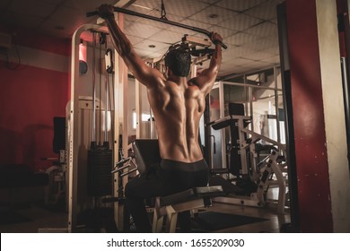 Fitness man working out lat pulldown training at gym - Powered by Shutterstock