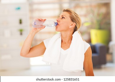 Fitness Mature Woman Drinking Water After Exercise