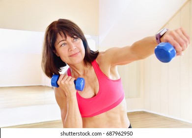 Fitness Mature Woman Working Out With Dumbbells. Healthy Lifestyle