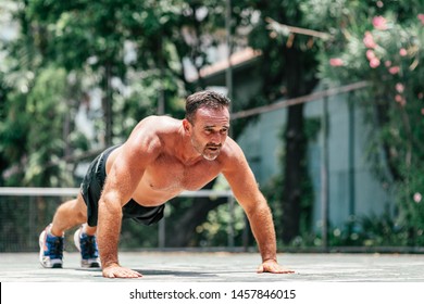 Fitness Middle Aged Man Doing Push-ups. Male Athlete Exercising Outdoors. Sports And Active Lifestyle. Body Goals. Horizontal Shot