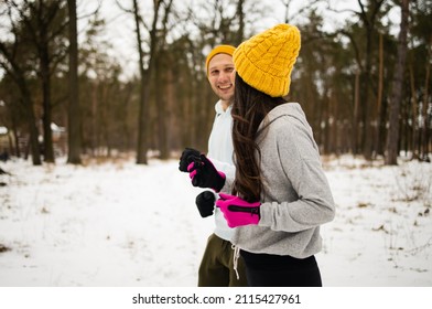 Fitness Mixed Race Couple Winter Morning Exercises On A Snowy Forest.