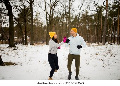 Fitness Mixed Race Couple Winter Morning Exercises On A Snowy Forest.