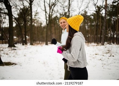 Fitness Mixed Race Couple Winter Morning Exercises On A Snowy Forest.