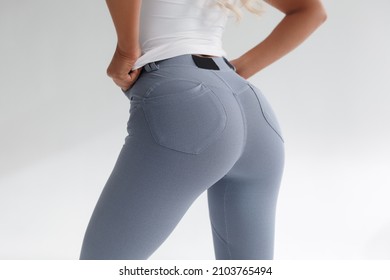 Fitness model in leggings with beautiful buttocks. Sporty booty