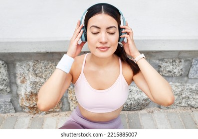 Fitness, Music And Woman With Headphones Sitting On Ground To Relax After Outdoor Workout, Running Or Yoga. Sports, Exercise And Streaming Motivation Or Meditation App And Enjoying Calm Playlist.