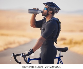 Fitness, nature and man cyclist drinking water at race, marathon or competition training. Sports, workout and thirsty male athlete with hydration for health at an outdoor cardio exercise with bicycle - Powered by Shutterstock