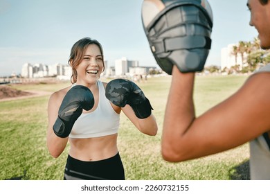 Fitness, personal trainer and boxing woman outdoor for exercise in nature park for health and wellness. Couple of friends happy about sports workout or fight with support, motivation and man coach - Powered by Shutterstock