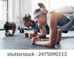 Fitness, personal trainer and plank exercise with group, healthy workout or training in gym for weight loss. Athlete, man and women together for power challenge, strong muscle at club or commitment