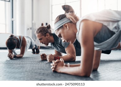 Fitness, personal trainer and plank exercise with group, healthy workout or training in gym for weight loss. Athlete, man and women together for power challenge, strong muscle at club or commitment