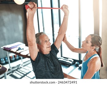 Fitness, personal trainer and senior man with resistance band in gym for physiotherapy, support or morning workout. Lens flare, woman coach and elderly patient for help, training or rehabilitation - Powered by Shutterstock