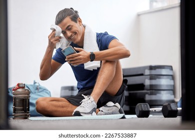 Fitness, phone or man with sweat on social media at gym in training, workout or exercise resting on break. Mobile app, digital or tired athlete relaxing on cellphone searching for body goals posts - Powered by Shutterstock