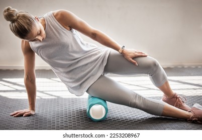 Fitness, physio massage and woman with roller on floor for leg tension and support in yoga workout at gym. Health, pilates and massaging for sports physiotherapy, girl on ground foam rolling muscle. - Powered by Shutterstock