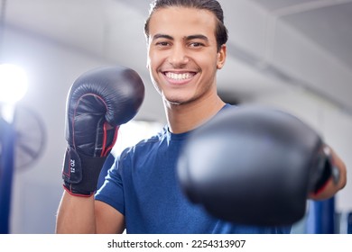 Fitness, portrait or happy boxer in training, cardio workout or exercise in a sports gym or health club. Face, man or healthy fighter in boxing gloves exercising with motivation, focus or goals - Powered by Shutterstock
