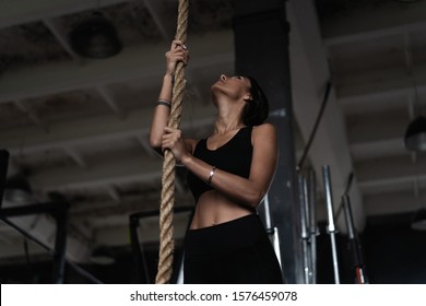 Fitness Rope Climb Exercise In Fitness Gym Workout. Athletic Woman Preparing For Rope Climbing Exercise