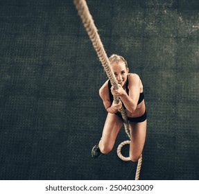 Fitness, rope climbing and smile with woman in gym from above for challenge, performance or workout. Exercise, target and wellness with happy climber in health club for physical or strength training - Powered by Shutterstock