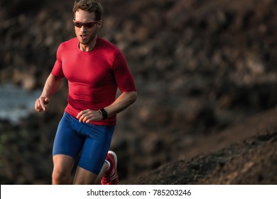 Fitness Runner Man Sport Athlete Ultra Running On Endurance Tough Mud Trail Race Competition Training Cardio Jogging In Mountain. Dark Exposure Of Male Adult In Compression Clothes, Sunglasses.