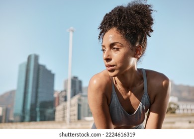 Fitness, runner and tired black woman in a city sweating from running exercise, cardio workout or training. Breathing, fatigue and sports athlete relaxing or resting on a break on a sunny summers day - Powered by Shutterstock