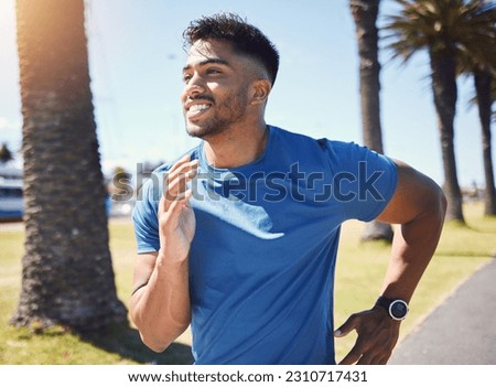 Fitness, running and man outdoor at park for exercise, training or cardio health. Happy Indian male athlete or runner in nature for a workout, run or jog while thinking of goals or performance