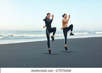 Fitness. Running On Beach As Lifestyle. Sport Couple In Fashion Sporty Outfit Working Out On Coast. Man And Woman Training Outdoor. Active Summer Vacation At Tropical Sea.