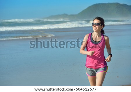 Fitness and running on beach, woman runner working out on sand near sea, healthy lifestyle and sport concept
