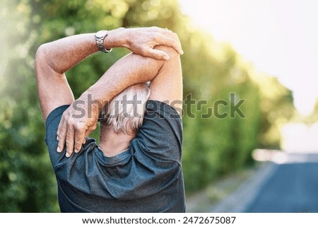Fitness, senior and man stretching arm in road for morning workout, wellness routine or warm up. Back, outdoor and elderly person for muscle flexibility, running exercise or getting ready in London