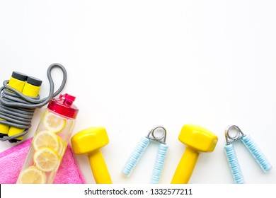 Fitness set with bars, bottle of water, towel and wrist builder on white background top view mock up - Powered by Shutterstock