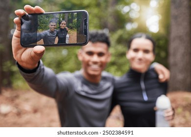 Fitness, smile and screen selfie of happy couple for cardio, exercise and running or outdoor marathon training. Man, woman and profile picture for health, wellness and forest trail for fresh air - Powered by Shutterstock