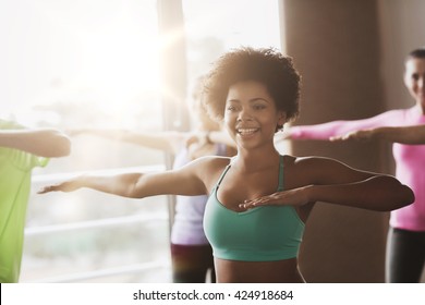 Fitness, Sport, Dance And Lifestyle Concept - Group Of Smiling People With Coach Dancing In Gym Or Studio