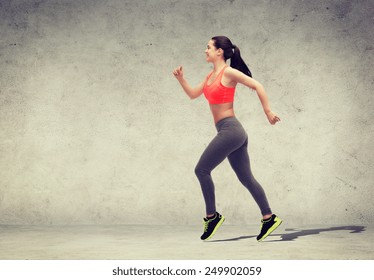 fitness, sport and dieting concept - beautiful sporty woman running or jumping - Shutterstock ID 249902059