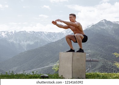 fitness, sport, exercising, training and lifestyle concept- strong and handsome muscular healthy european blonde man doing plyometric jump exercise in crossfit workout in mountains fitness park. - Powered by Shutterstock