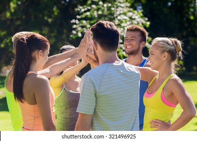 fitness, sport, friendship and healthy lifestyle concept - group of happy teenage friends or sportsmen making high five outdoors - Powered by Shutterstock