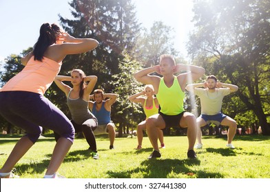 fitness, sport, friendship and healthy lifestyle concept - group of teenage friends or sportsmen exercising and doing squats at boot camp - Powered by Shutterstock