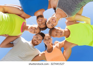 fitness, sport, friendship and healthy lifestyle concept - group of happy teenage friends or sportsmen in circle outdoors - Powered by Shutterstock