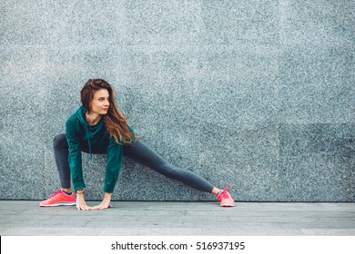 Fitness sport girl in fashion sportswear doing yoga fitness exercise in the street  outdoor sports  urban style
