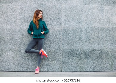 Fitness sport girl in fashion sportswear doing yoga fitness exercise in the street, outdoor sports, urban style